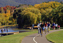 People riding around a lake in the ACT