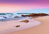 Neal Pritchard: A photo of a purple pink toned sky and waves crashing onto rocks at Apollo Bay in Victoria