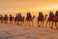 Neal Pritchard: A photo of people riding camels on Cable Beach WA